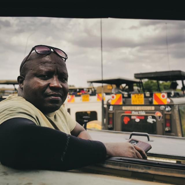 Michael, founder and lead guide of Savanna Lenses Africa Safaris, in a safari vehicle in Kenya